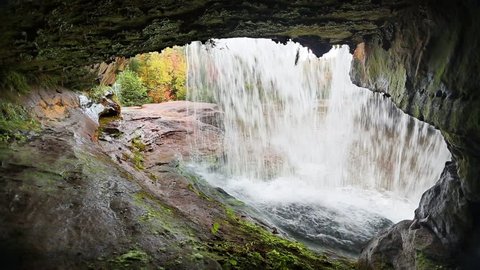 Loop features a view from beneath a waterfall in autumn. O Kun de Kun Falls, is located in the western Upper Peninsula of Michigan.