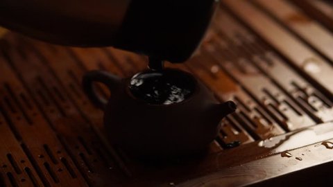 teapot from Yixing clay, drenched with boiling water and covered with a lid 3