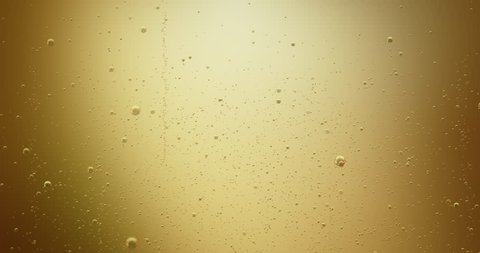 Gold champagne bubbles in 4 K. High quality render of bubbles are rising inside a glass of champagne background animation. Ideal to use for Christmas, celebration and party videos as background. 