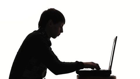 Silhouette Of Young Man Working At Laptop,