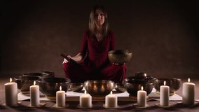 Woman playing a singing bowls also known as Tibetan Singing Bowls, rin gongs, Himalayan bowls or suzu gongs

