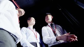 4k / Ultra HD version Two male and one female IT engineers of mixed ethnicity are having a discussion about the network servers in a dark data center. Shot on RED Epic - Powered by Shutterstock - Get 15% off with code: PIKWIZARD15