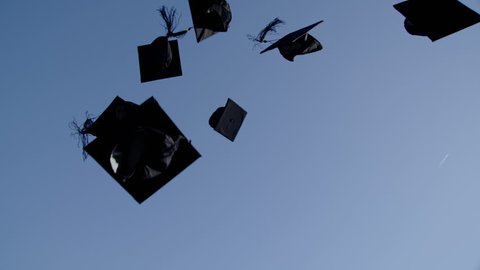 4k / Ultra HD version Graduation caps are tossed into the air on a bright sunny day and then fall out of shot. No people can be seen. In slow motion. Shot on RED Epic