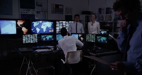 4k / Ultra HD version Security personnel in a busy system control room are taking calls via headsets and either issuing or receiving instructions. In slow motion.