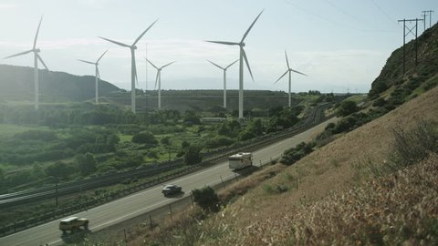windmills blowing next to highway