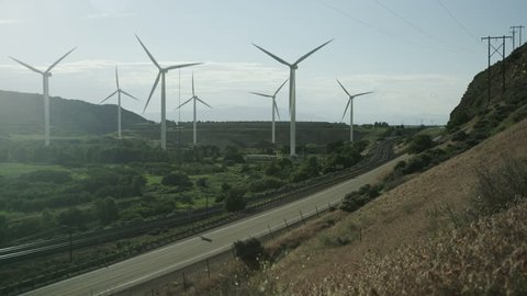 windmills blowing next to highway