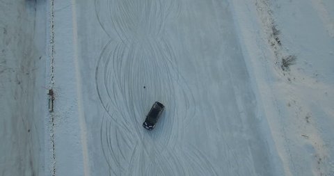 An aerial view over a test driving by rally car on a snow slope in north Italy
