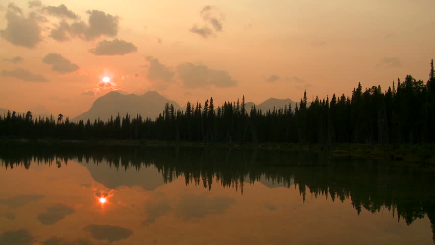 Pan of alpine lake at sunset