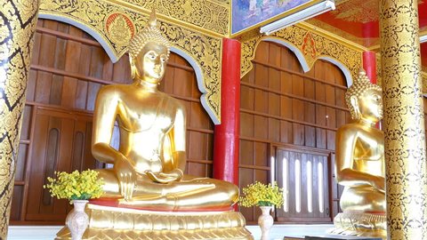 row of golden buddha statue in monastery in thailand