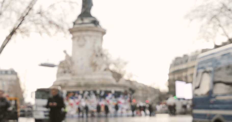 Defocused view of people gather to place candles at Place de la Republique (Republic square) in support of the victims after terrorist attack on November 13 2015 in Paris, France.