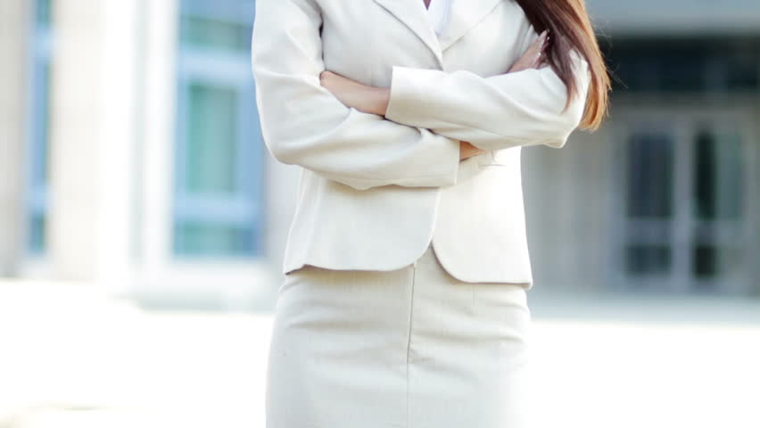 Attractive young caucasian business woman outside office building