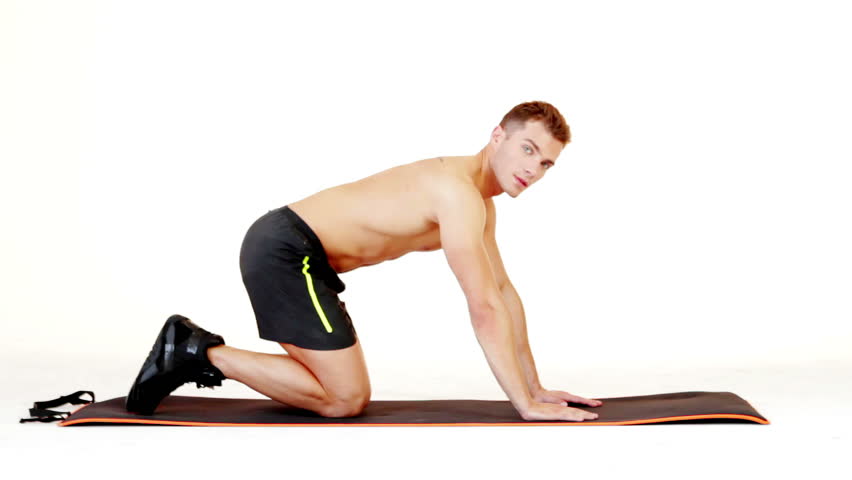 Handsome muscular man exercising on isolated white background