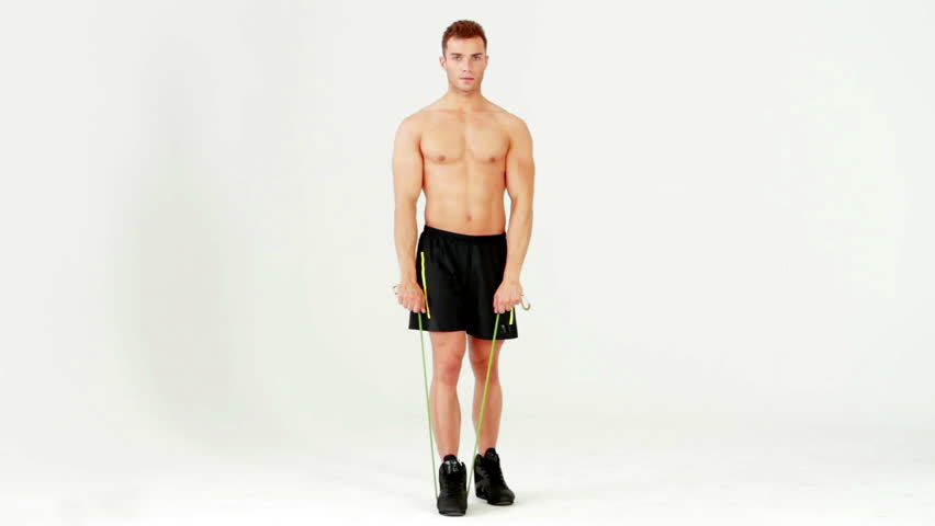 Handsome muscular man exercising with rubber on white background