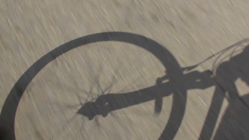 The shadow of a bicycle.  Rider's perspective.