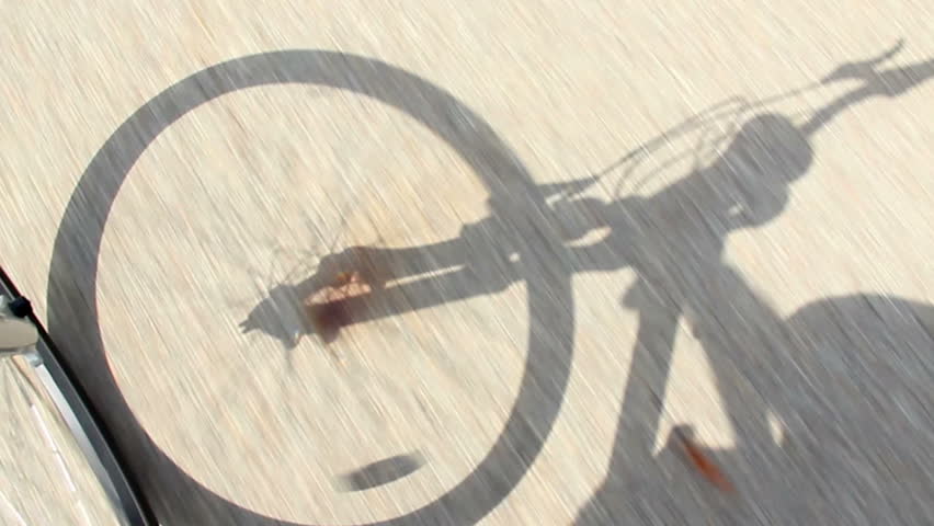 The shadow of a bicycle.  Rider's perspective.