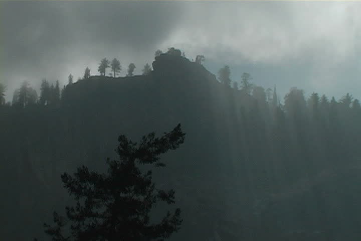 Sun rays filtering through clouds in Yosemite National Park.