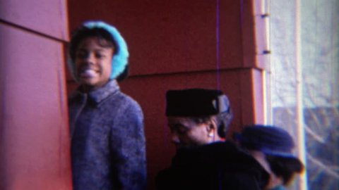 CARMEL, INDIANA 1969: African American women funny formal style colorful hats and earmuffs.