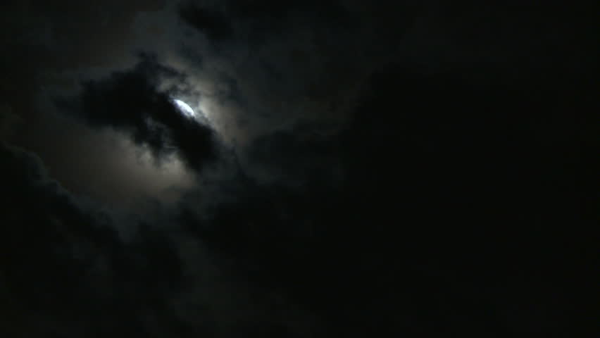 Clouds before moon at night