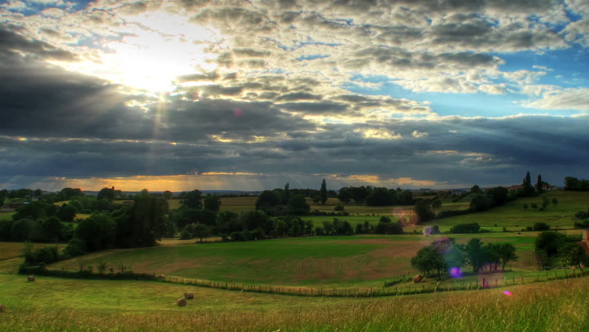 HDR time lapse of sunset over hills, high dynamic range imaging.