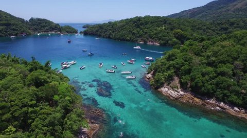 Famous blue lake (lagoa azul) dive area, with a transparent water and touristic boats discovering the archipelago. Aerial drone view, Ilha Grande (Big Island), Angra dos Reis - Rio de Janeiro - Brazil