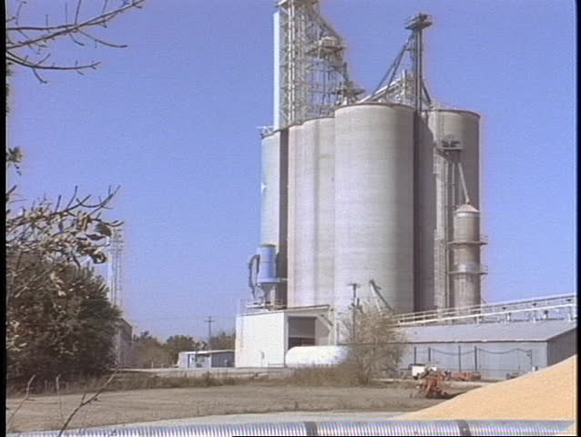 A granary sits next to a huge pyramid of wheat.