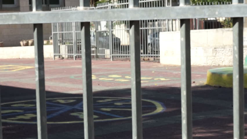 Empty school yard with fence
Dolly shot of Empty school yard 
