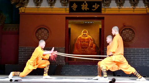 Dec.18,2015-Dengfeng,China:  Shaolin temple monks are practicing martial skills on the stage for the tourists.  