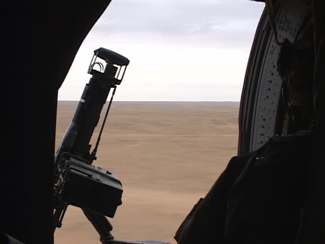 A Black Hawk helicopter carrying soldiers flies over Iraq.