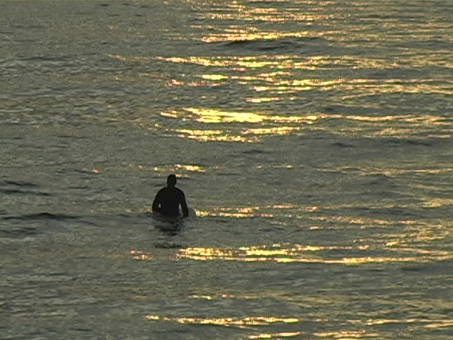 A surfer enjoys the calm between waves.