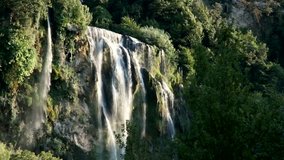 Mountain waterfall among greenery 