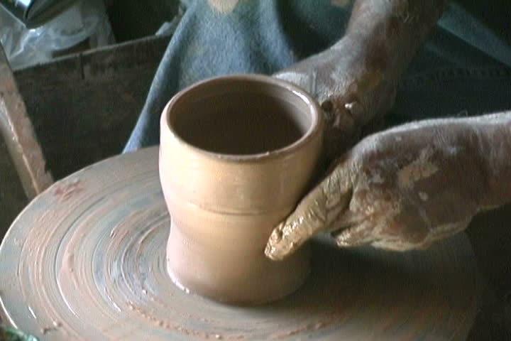 A potter making a small vase.