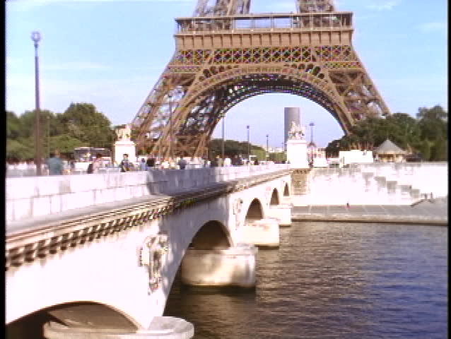 The Eiffel Tower rises high over the Seine river in Paris.