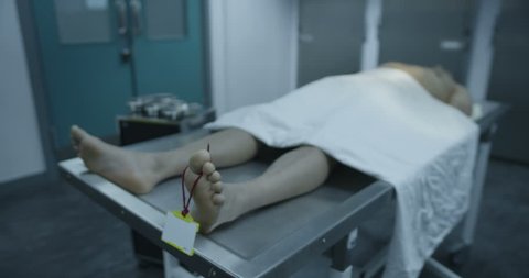 4k / Ultra HD version The lifeless body of a young mixed race male is laid out on the autopsy table, ready for the medical examiner to begin his work. In slow motion. Shot on RED Epic