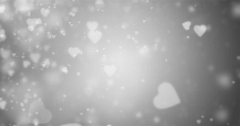 Seamless loop of white heart-shaped particles on a grey background