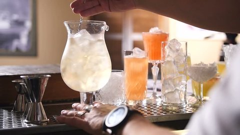 Bartender mixing exotic drink, slowmotion footage