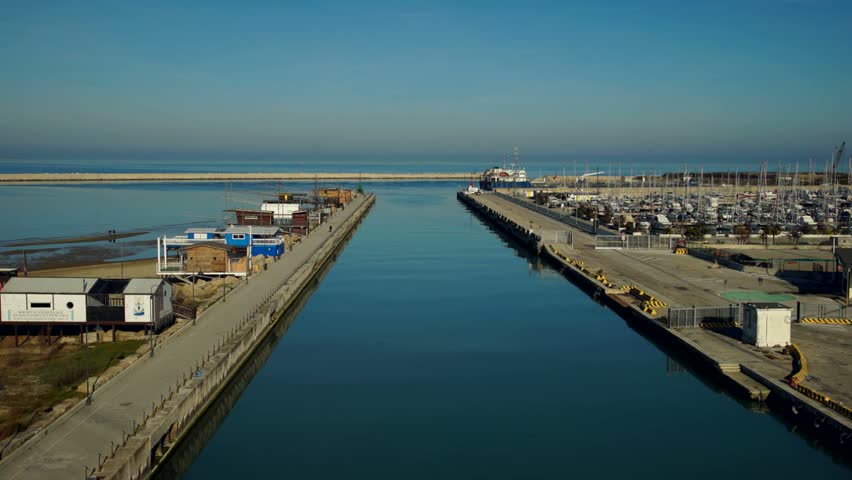 Time lapse of fishing boat coming back to harbor at dusk. Pescara, Italy.