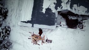 Overhead Aerial Video of Lumberjack Splitting his Wood for the Winter