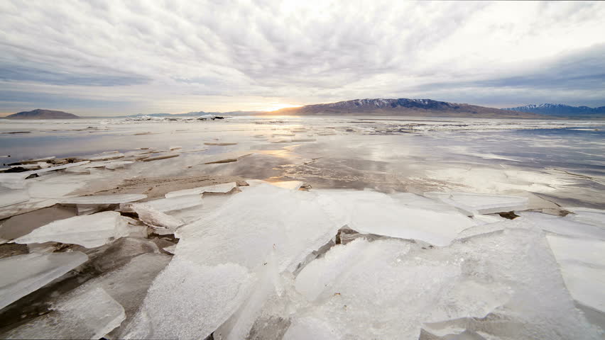 Time lapse of a sunset over Utah Lake after it has been frozen and chunks of ice have piled up. Shot on a slider.