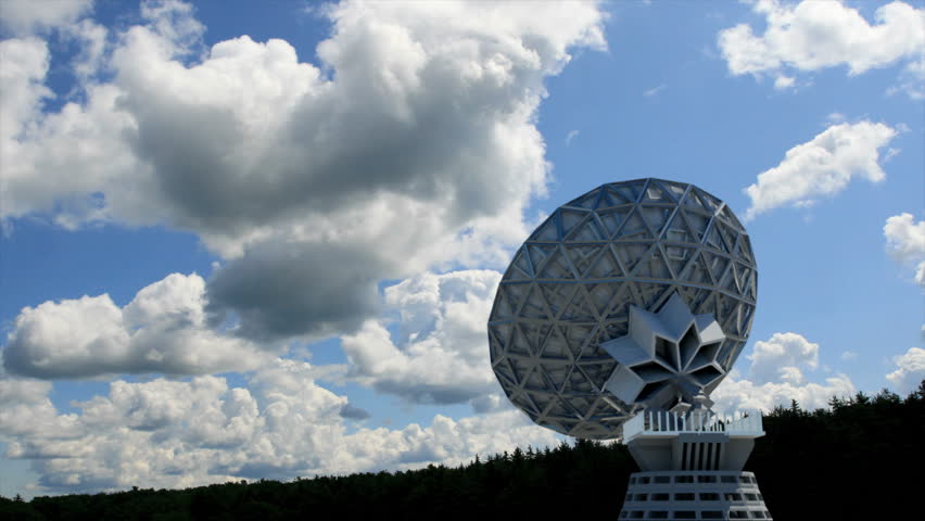 A satellite dish (CG) composited over a beautiful time-lapse of the sky.   