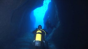 cave dive cave diving underwater scuba divers exploring caves ocean scenery sun beams and rays background