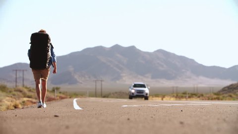 Two Men On Vacation Hitchhiking Along Road Shot On R3D