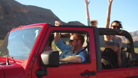 Friends On Road Trip Driving In Convertible Car Shot On R3D
