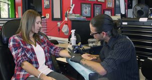 Woman Sits In Chair Having Tattoo In Parlor Shot On R3D