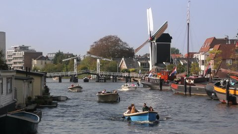 Boats sail in a canal with drawbridge and windmill on September 24, 2011 in Leiden, Holland. 