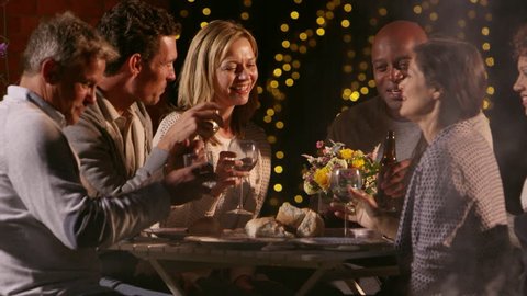 Mature Friends Enjoying Outdoor Evening Meal Shot On R3D स्टॉक वीडियो