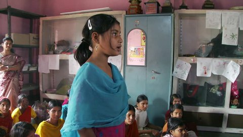 Baruipur, India - CIRCA 2013 - Girl stands and recites in classroom