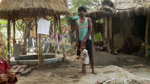 Baruipur, India - CIRCA 2013 - Indian man and baby girl standing