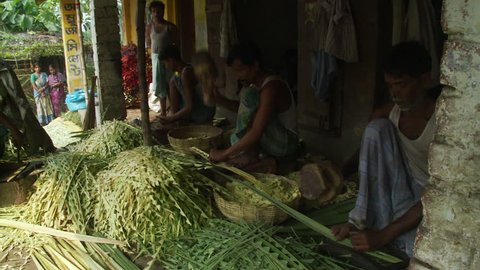 Baruipur, India - CIRCA 2013 - Three men making plant based crafts