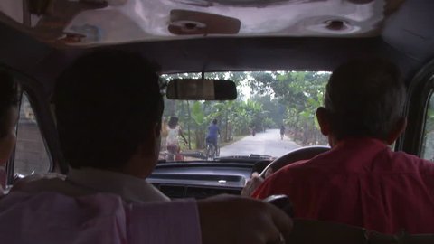 Baruipur, India - CIRCA 2013 - View of two men in front seat of car