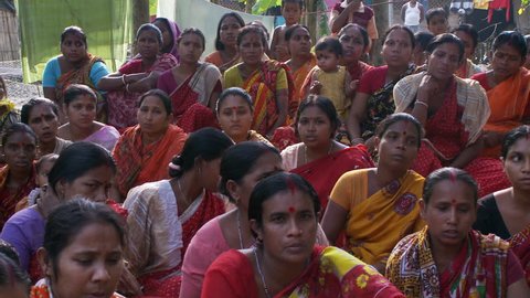 Baruipur, India - CIRCA 2013 - Women chanting and raising arms at women meeting